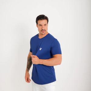 Camiseta de poliamida azul — logo Vistorr no peito — mãos soltas, olhar à esquerda