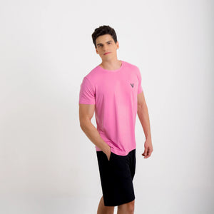 Camiseta de poliamida rosa — logo Vistorr no peito — mãos soltas, olhar para a câmera, logo legível